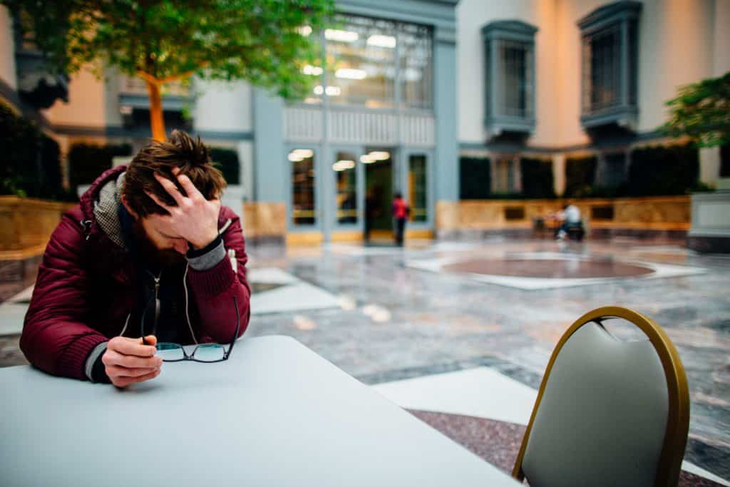 A person sitting at a table experiencing employee burnout